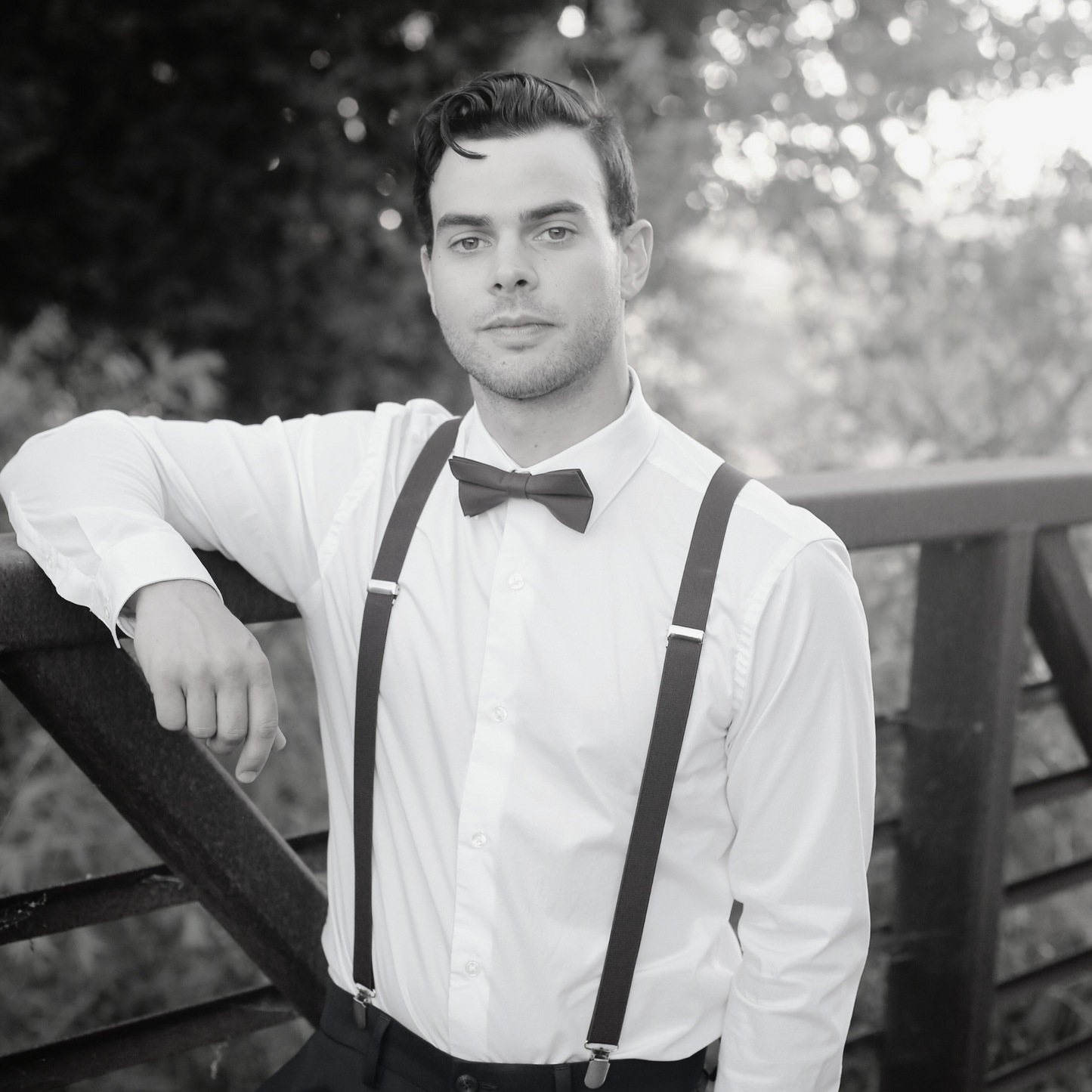 a man wearing a bow tie and suspenders