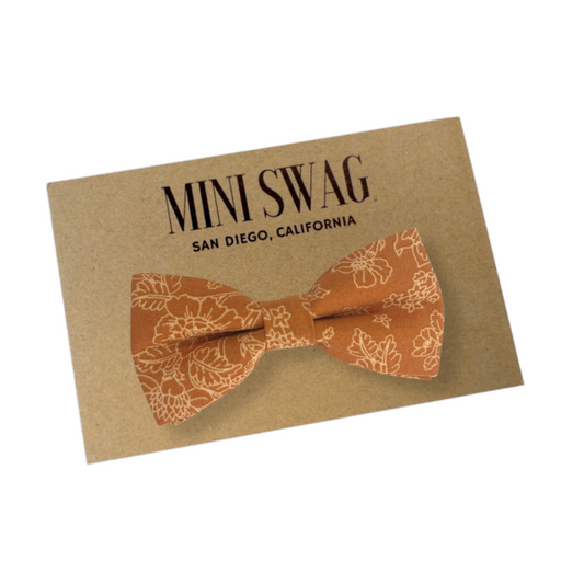 a brown bow tie on top of a card