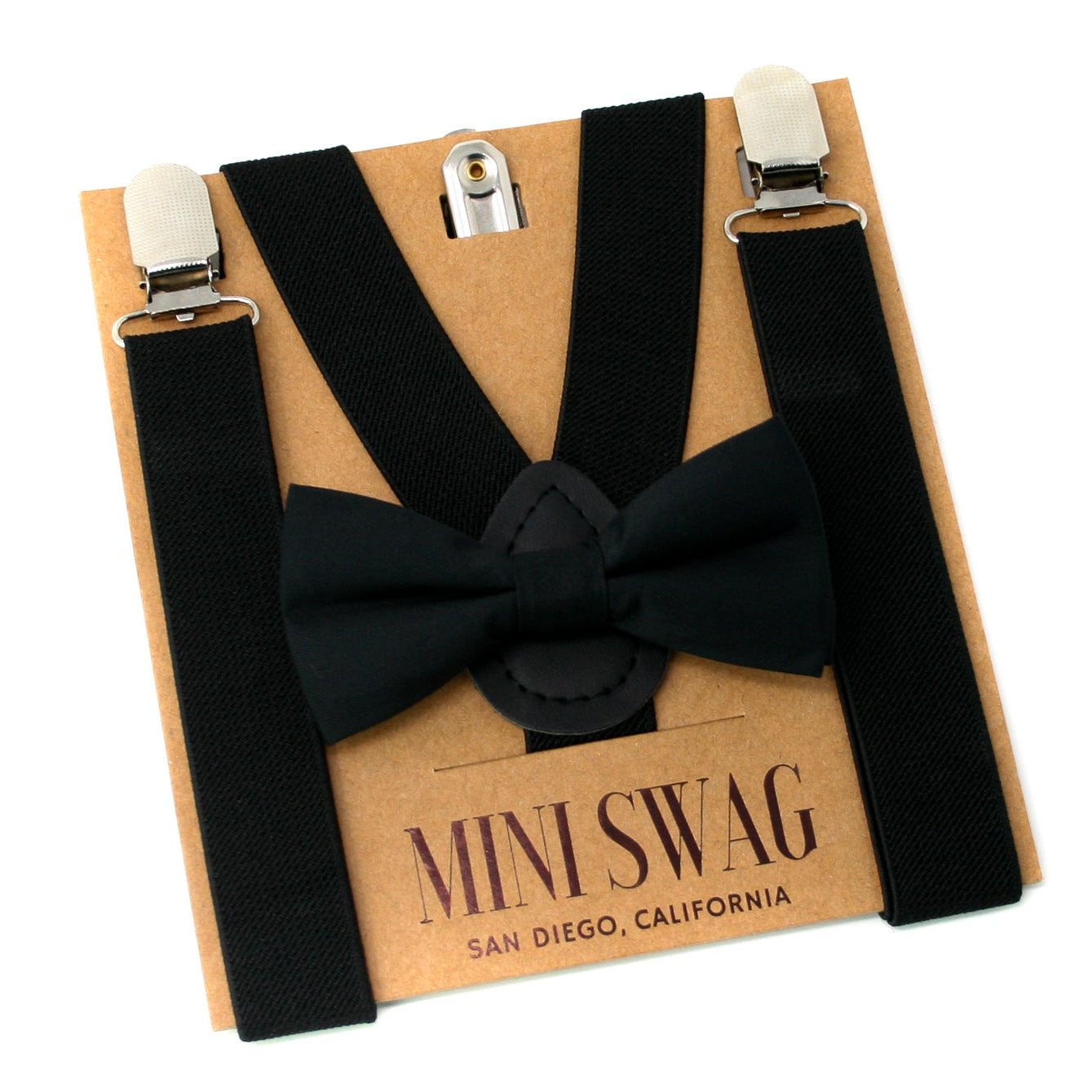 Black bow tie and suspenders on a cardboard box with 'Mini Swag' branding.