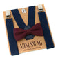 Navy suspenders with a burgundy bow tie on a 'Mini Swag' branded card.
