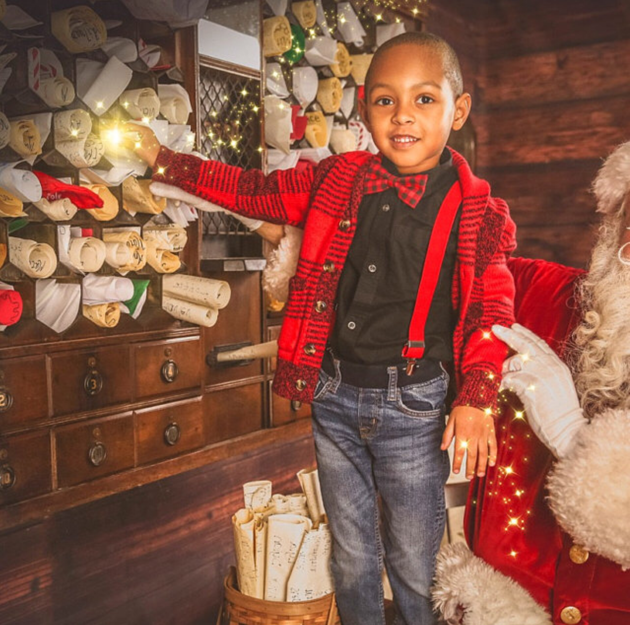Child in a festive setting with Santa Claus, surrounded by Christmas decorations.