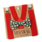 Red suspenders with a green bow tie featuring Santa Claus patterns on a cardboard backing with 'Mini Swag' branding.