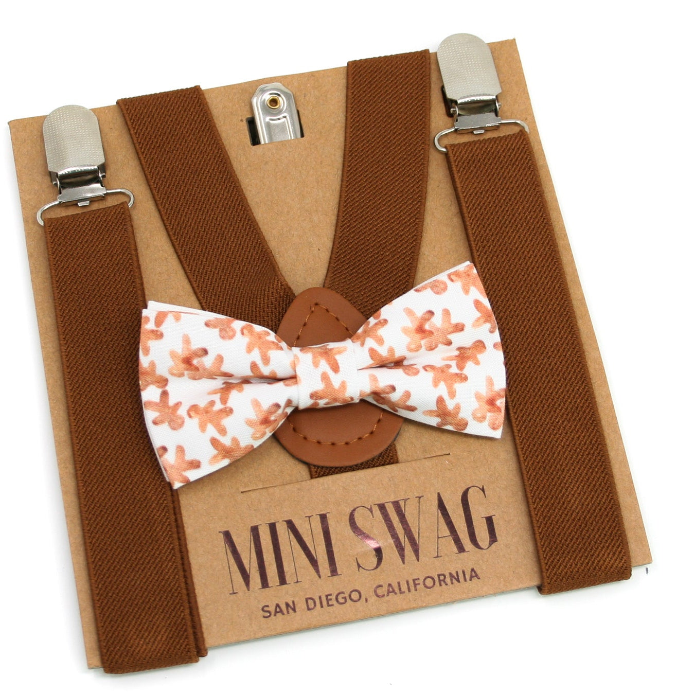 Brown suspenders with a gingerbread bow tie on a Mini Swag branded box.