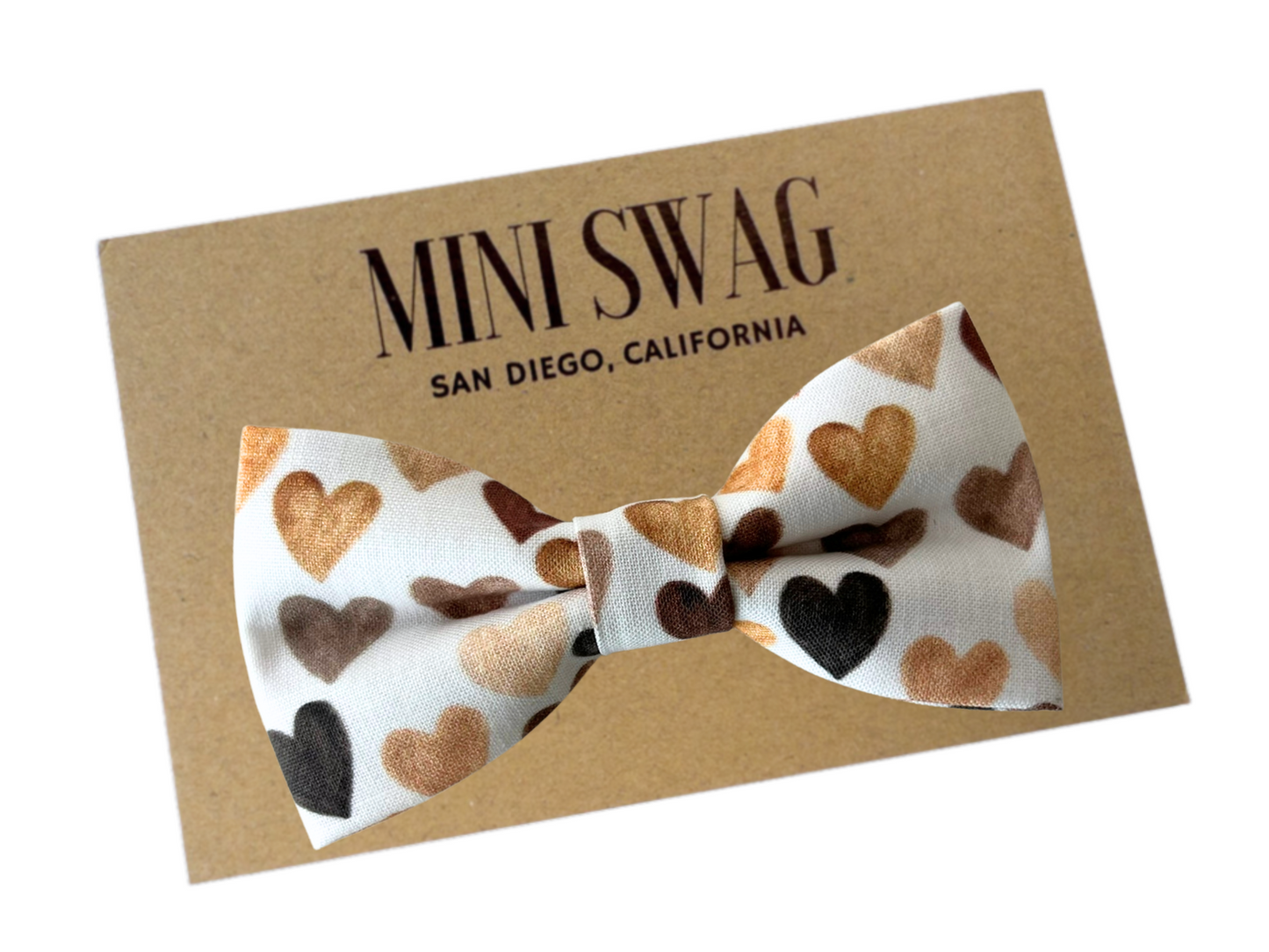 heart bow tie in shades of brown on white background on board