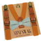Camel brown suspenders with brown leather straps and a dusty sage bow tie on a 'Mini Swag' branded card.