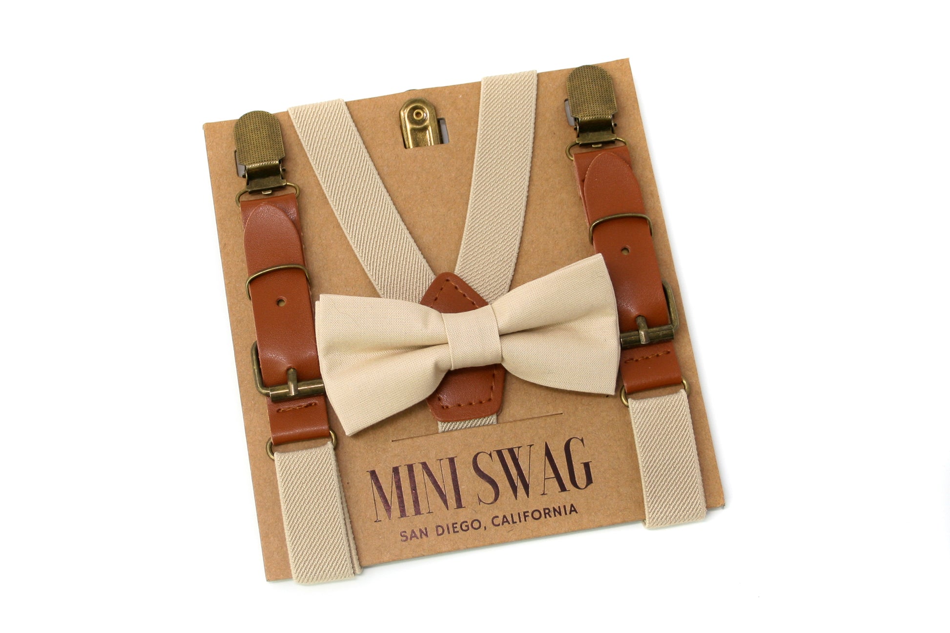 Beige bow tie and suspenders set on a 'Mini Swag' branded box with a white background.