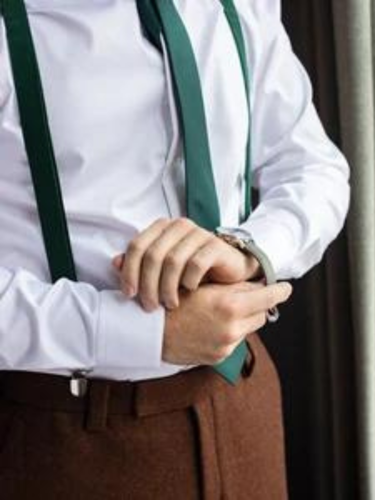 a man wearing a white shirt and green tie