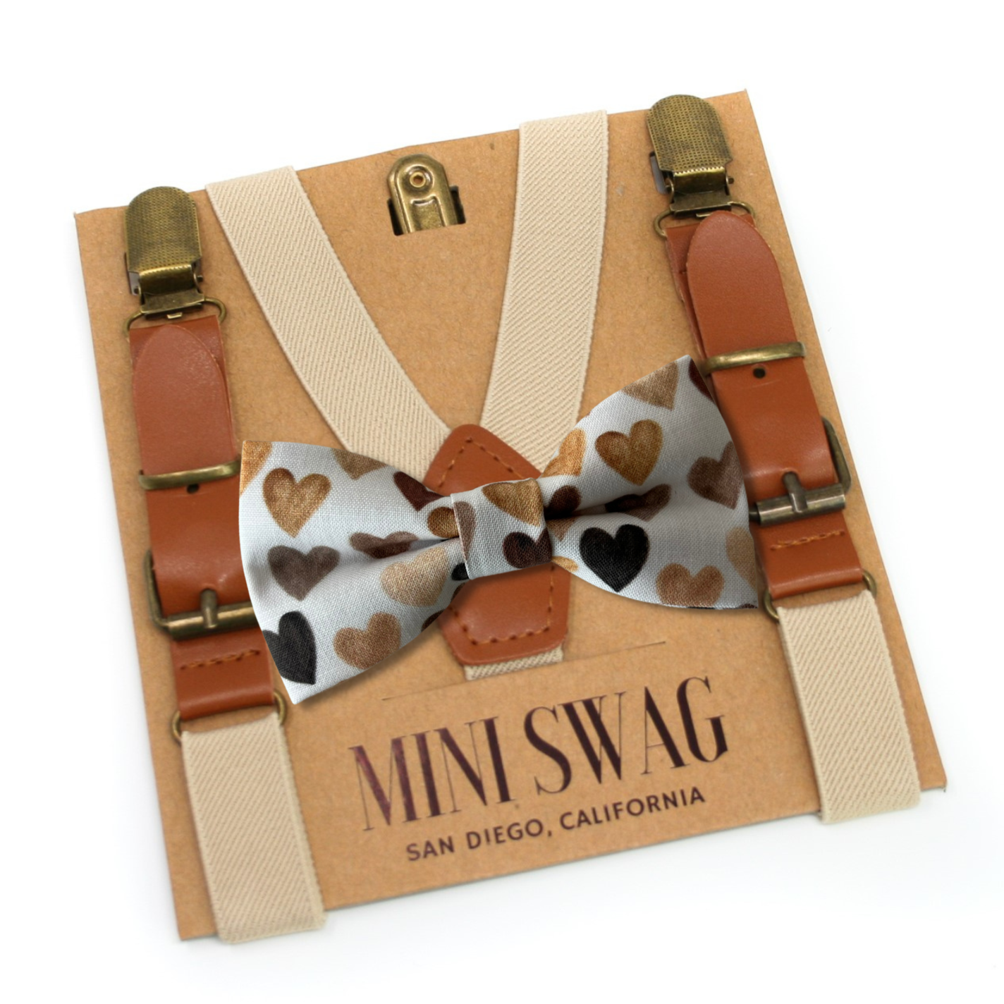 heart bow tie in shades of brown on white background khaki leather buckle suspenders