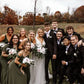 Wedding party with bride and groom. Groomsmen are wearing olive green bow ties