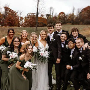 Wedding party with bride and groom. Groomsmen are wearing olive green bow ties