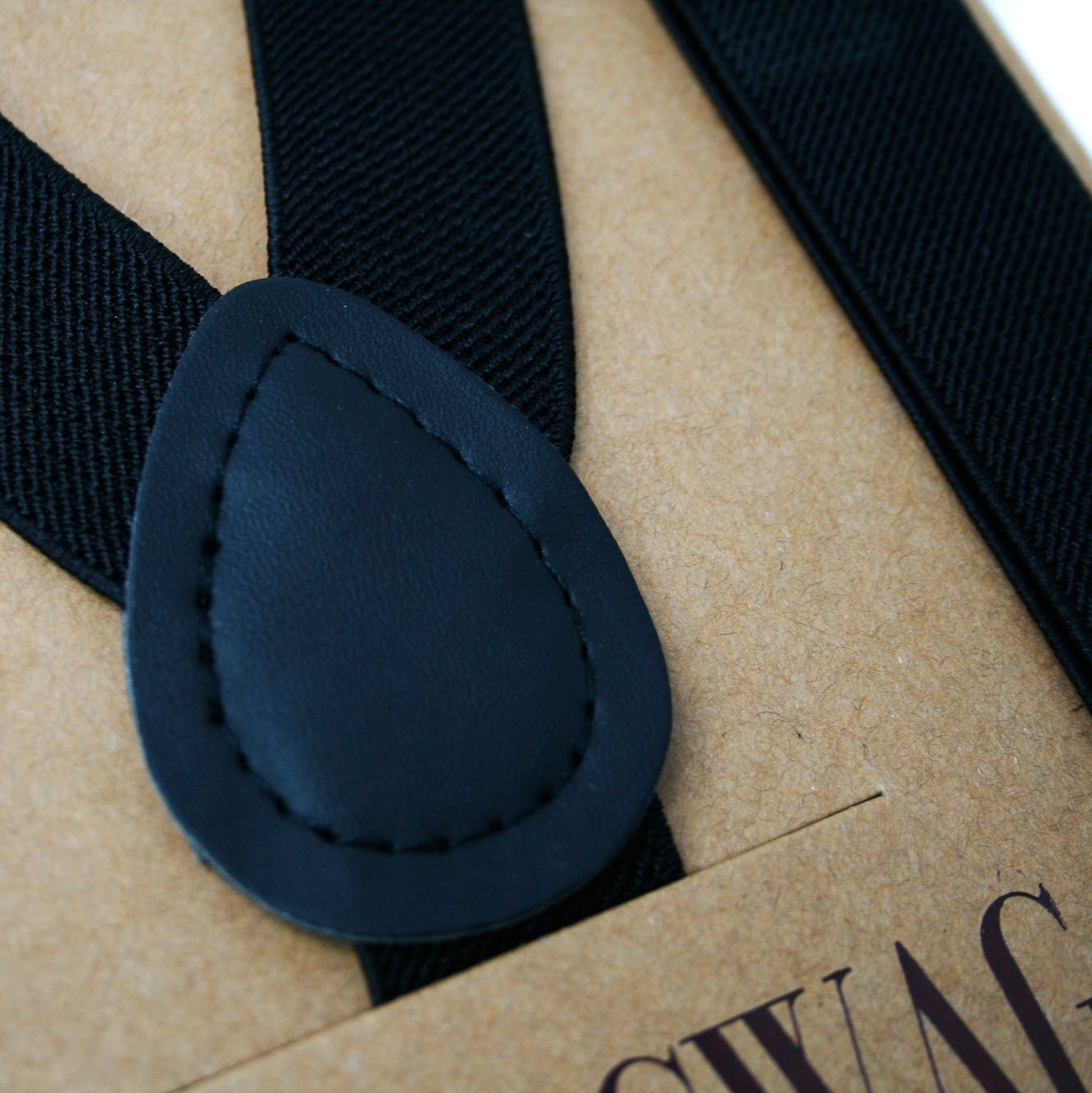 Black suspenders with matching black patch